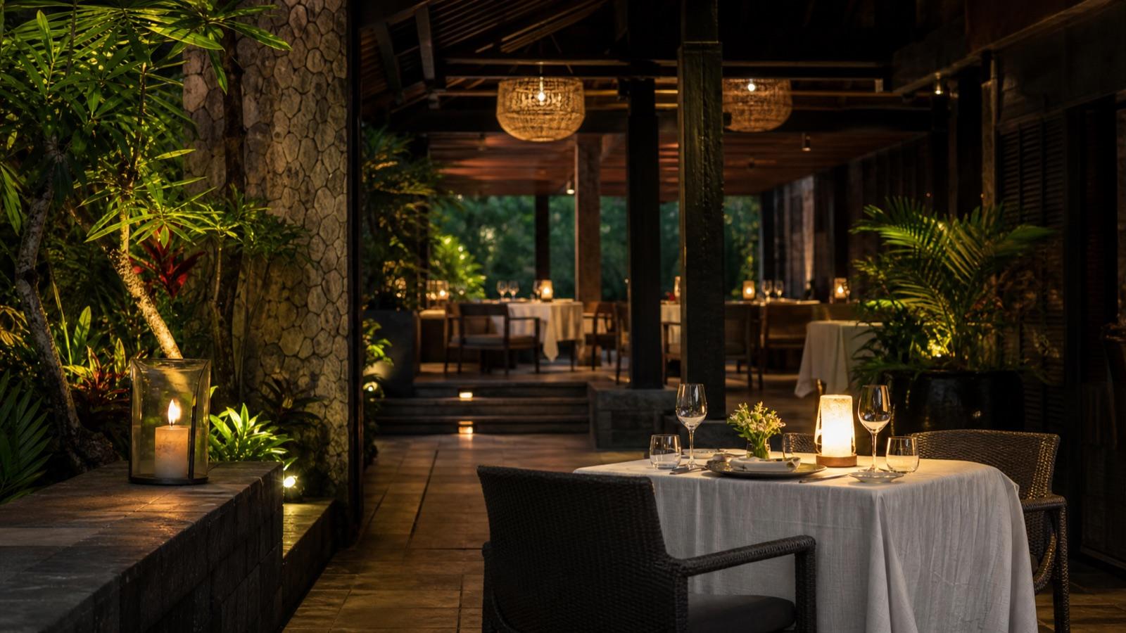 A softly lit table for two in a quiet tropical dining pavilion
